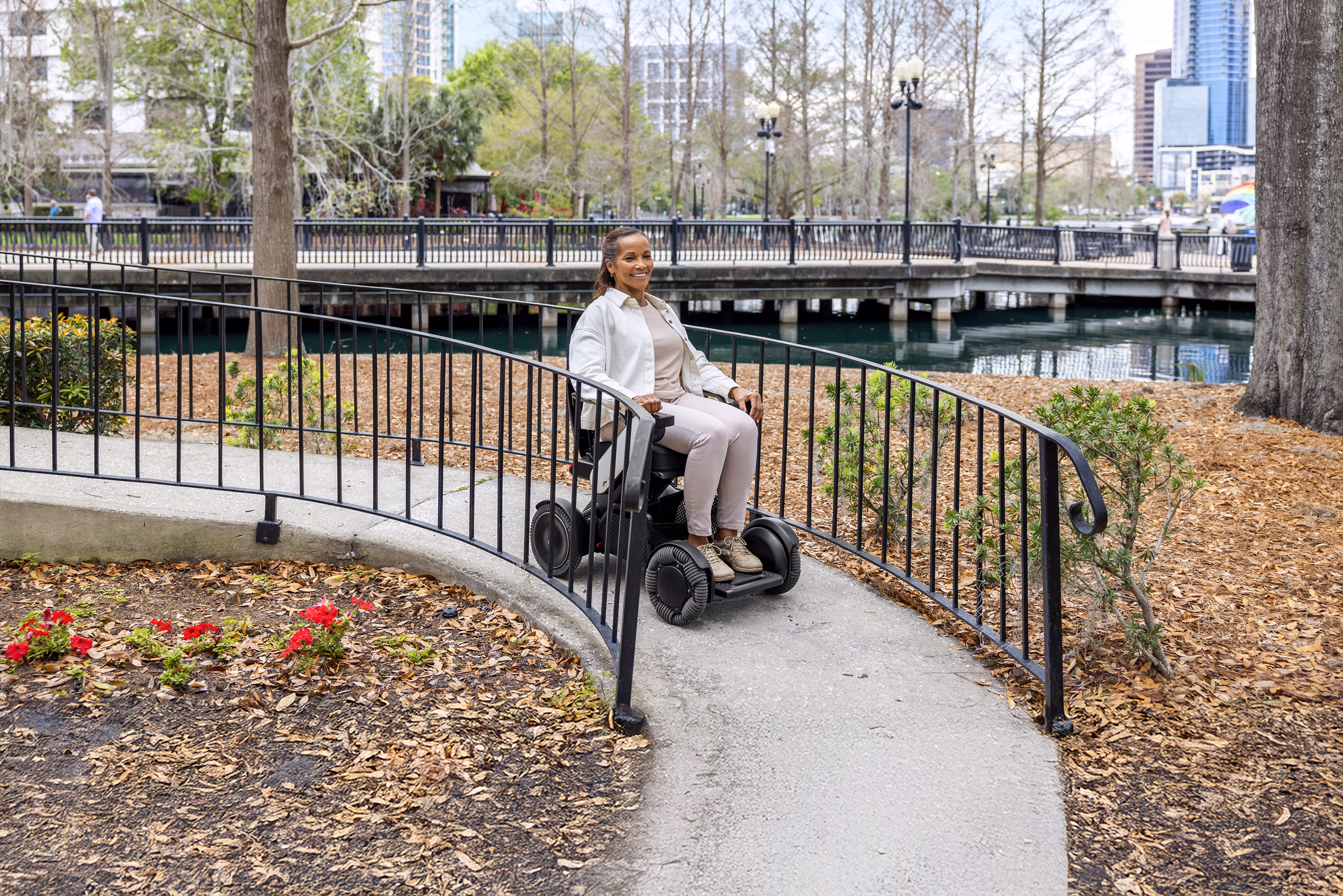 Women outside on a WHILL Model C2 powerchair.