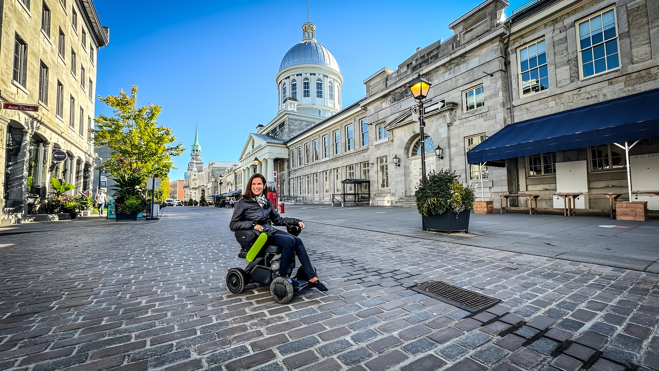 Women outside in a WHILL Model C2 portable powerchair.